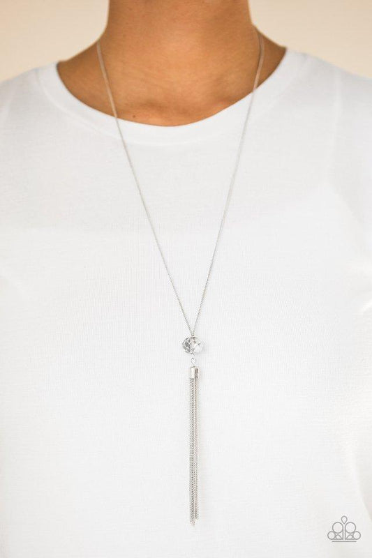 Socialite of the Season - Silver Necklace - Paparazzi Accessories - Splashed in metallic shimmer, a smoky crystal-like bead swings from the bottom of a lengthened silver chain, giving way to a shimmering silver tassel for a glamorous finish.