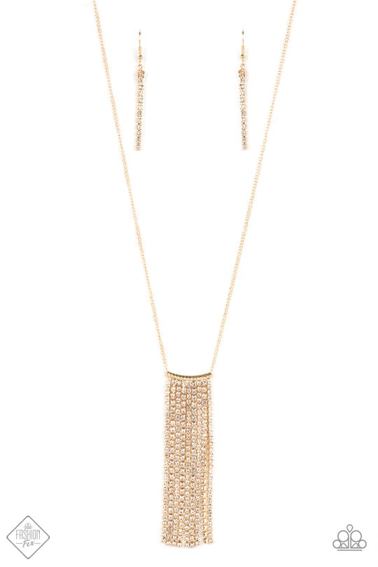Stellar Crescendo - Gold Fashion Necklace - Paparazzi Accessories - Set in dainty gold fittings, strand after strand of sparkly white rhinestones streams out from the bottom of a curved gold rod. Etched in slanted rows of geometric texture, the gold rod glides along the bottom of an elongated gold chain, creating tangible twinkle. 