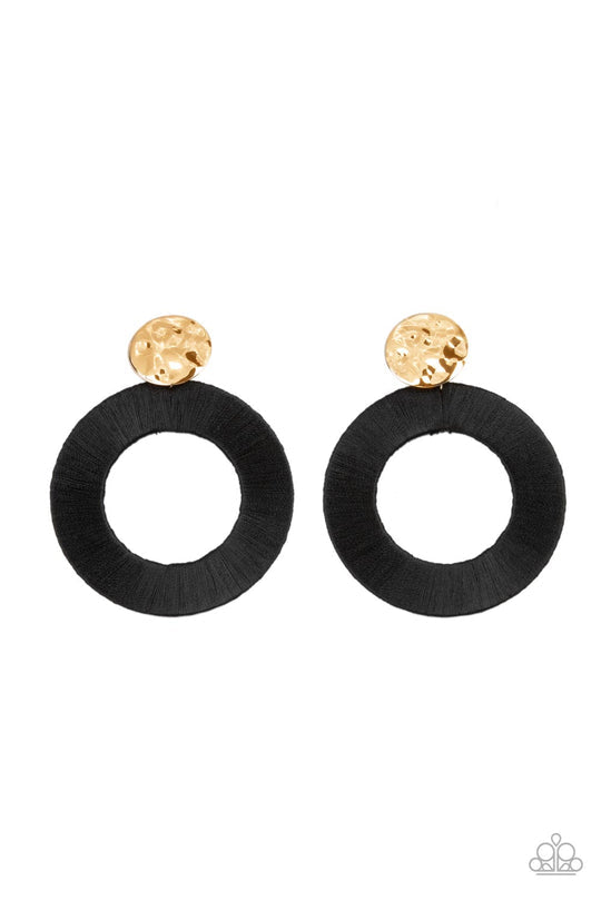 Strategically Sassy Black and Gold Earrings - Paparazzi Accessories -A hammered gold disc gives way to an oversized metal hoop wrapped in black thread, resulting in a modern lure. Earring attaches to a standard post fitting. Sold as one pair of post earrings.