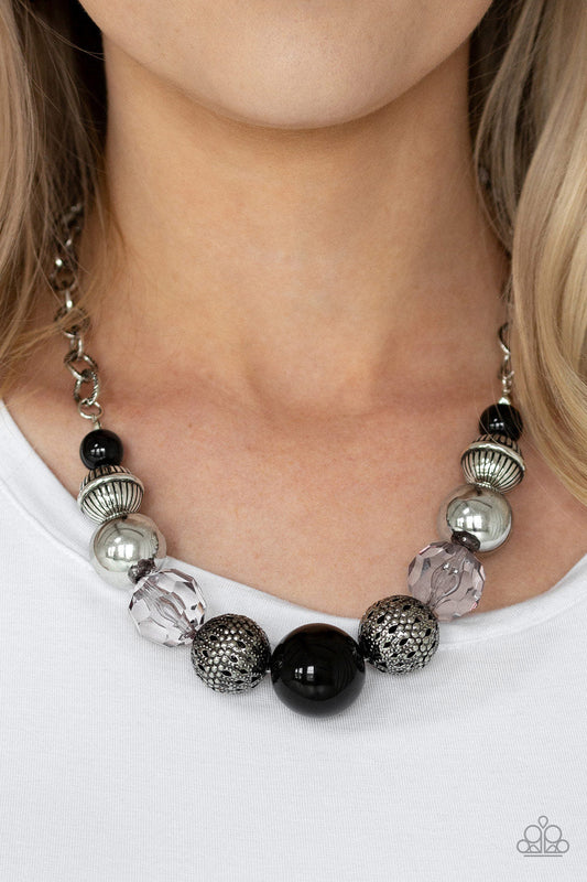 Sugar, Sugar - Black and Silver Bead Necklace - Paparazzi Accessories - A collection of antiqued silver beads, smoky crystal-like beads, and oversized black beads are threaded along an invisible wire below the collar. Textured in linear patterns, an antiqued silver chain attaches to the colorful compilation for a statement-making finish. Features an adjustable clasp closure fashion necklace.