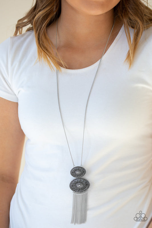 Sun Goddess - Silver Necklace - Paparazzi Accessories - Embossed in radiant sunburst patterns, two oval silver frames connect at the bottom of a lengthened silver chain. Glistening silver chains stream from the bottom of the stacked pendant, adding a wanderlust flair to the tribal inspired look. Features an adjustable clasp closure. Sold as one individual necklace.