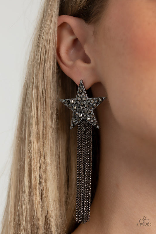 Superstar Solo - Black Earrings - Paparazzi Accessories - Bejeweled Accessories By Kristie - A curtain of gunmetal chains streams out from the bottom of an oversized gunmetal star encrusted in smoky hematite rhinestones, resulting in a stellar tassel. Earring attaches to a standard post fitting. Sold as one pair of post earrings.