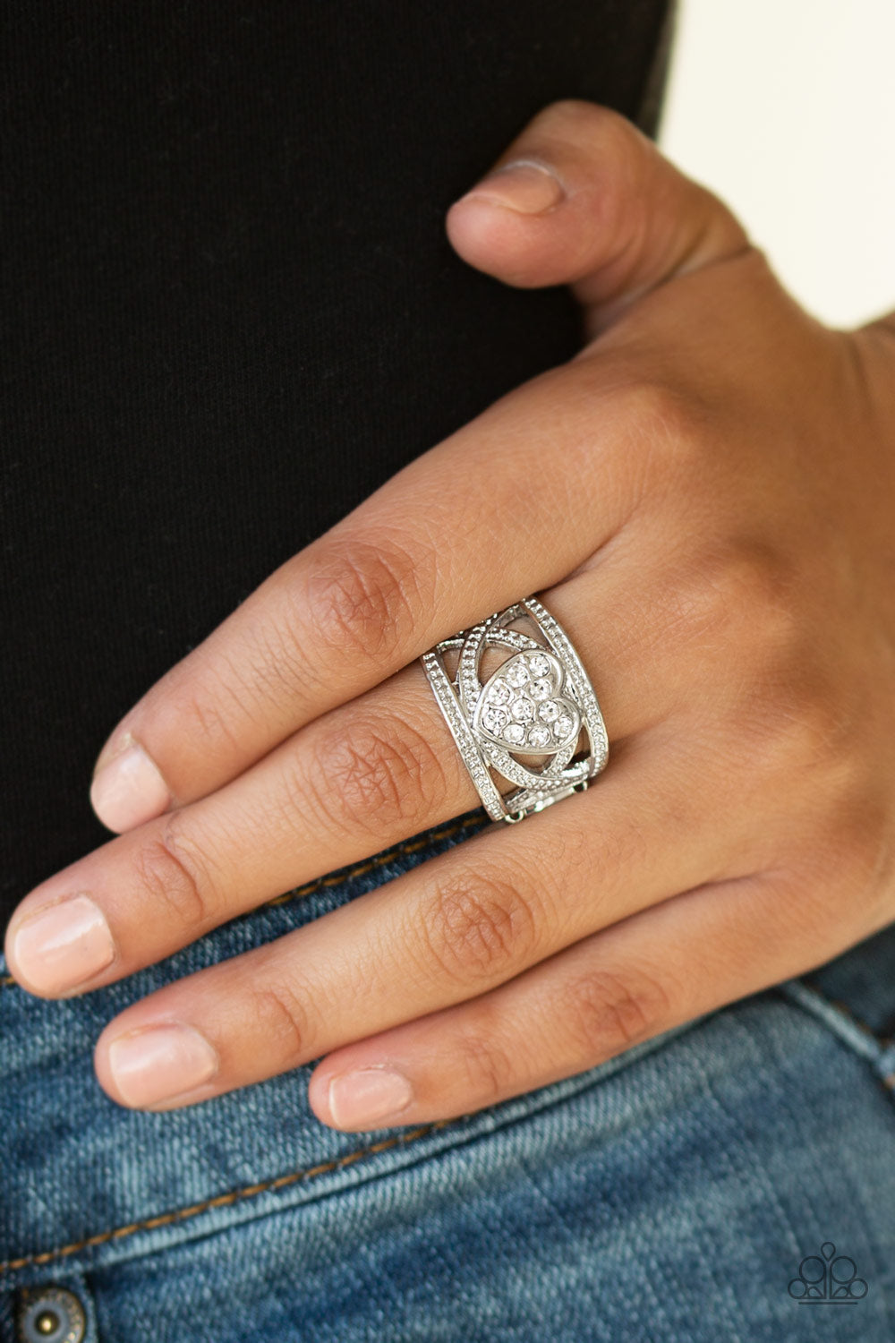 Sweetly Sweetheart - White and Silver Heart Ring - Paparazzi Accessories - Dotted in dainty silver studs, glistening silver bands weave across the finger. A white rhinestone encrusted silver heart adorns the center, creating a flirtatious centerpiece. Features a stretchy band for a flexible fit. Sold as one individual ring. 