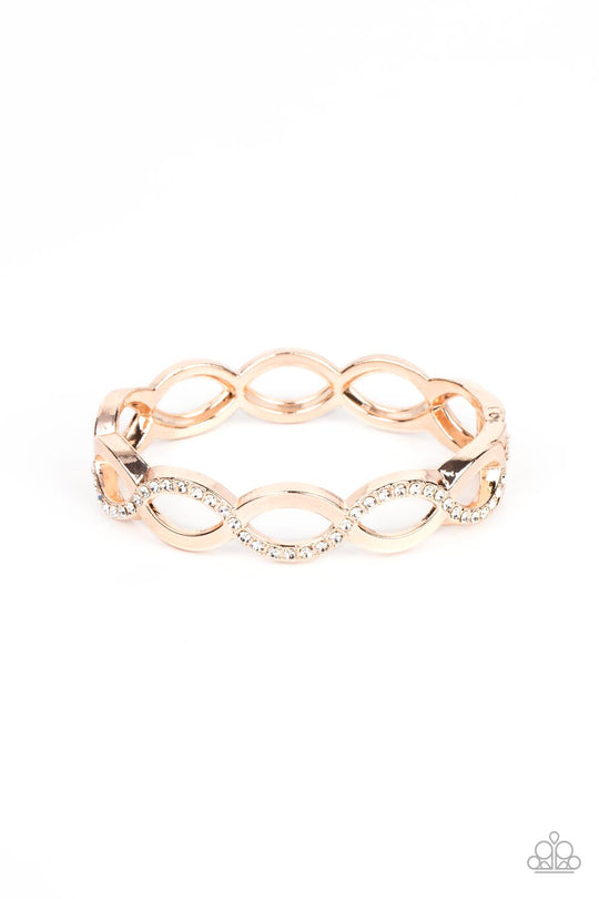 Tailored Twinkle - Rose Gold Bracelet - Paparazzi Accessories - Rose gold bars elegantly intertwine into infinity inspired frames that delicately hinge around the wrist. The front of the flawless centerpiece is dusted in a wavy row of white rhinestones, adding a timeless twinkle to the versatile design. Features a hinged closure. Sold as one individual bracelet.