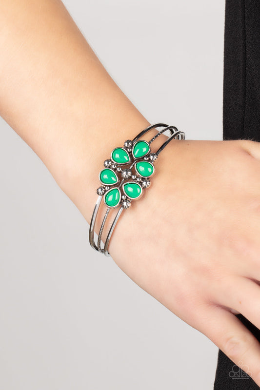 Taj Mahal Meadow - Green and Silver Floral Cuff Bracelet - Paparazzi Accessories - A whimsical collection of glassy Leprechaun teardrop beads, dainty silver studs, and silver floral accents coalesce into a colorful centerpiece atop a layered silver cuff. Sold as one individual bracelet.