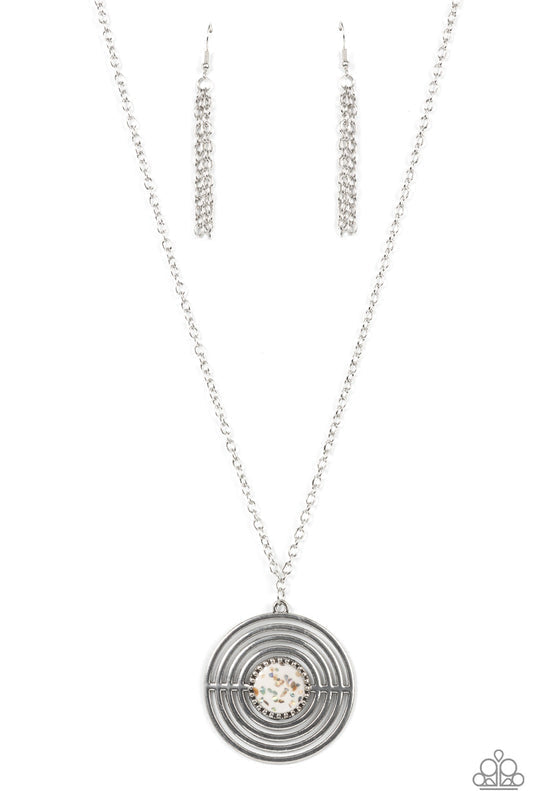 Targeted Tranquility - White and Silver Necklace - Paparazzi Accessories - Flecked in iridescent shell-like accents, a studded white frame adorns the center of an oversized silver pendant rippling with concentric circles at the bottom of an extended silver chain for a dizzying pop of color. Features an adjustable clasp closure.