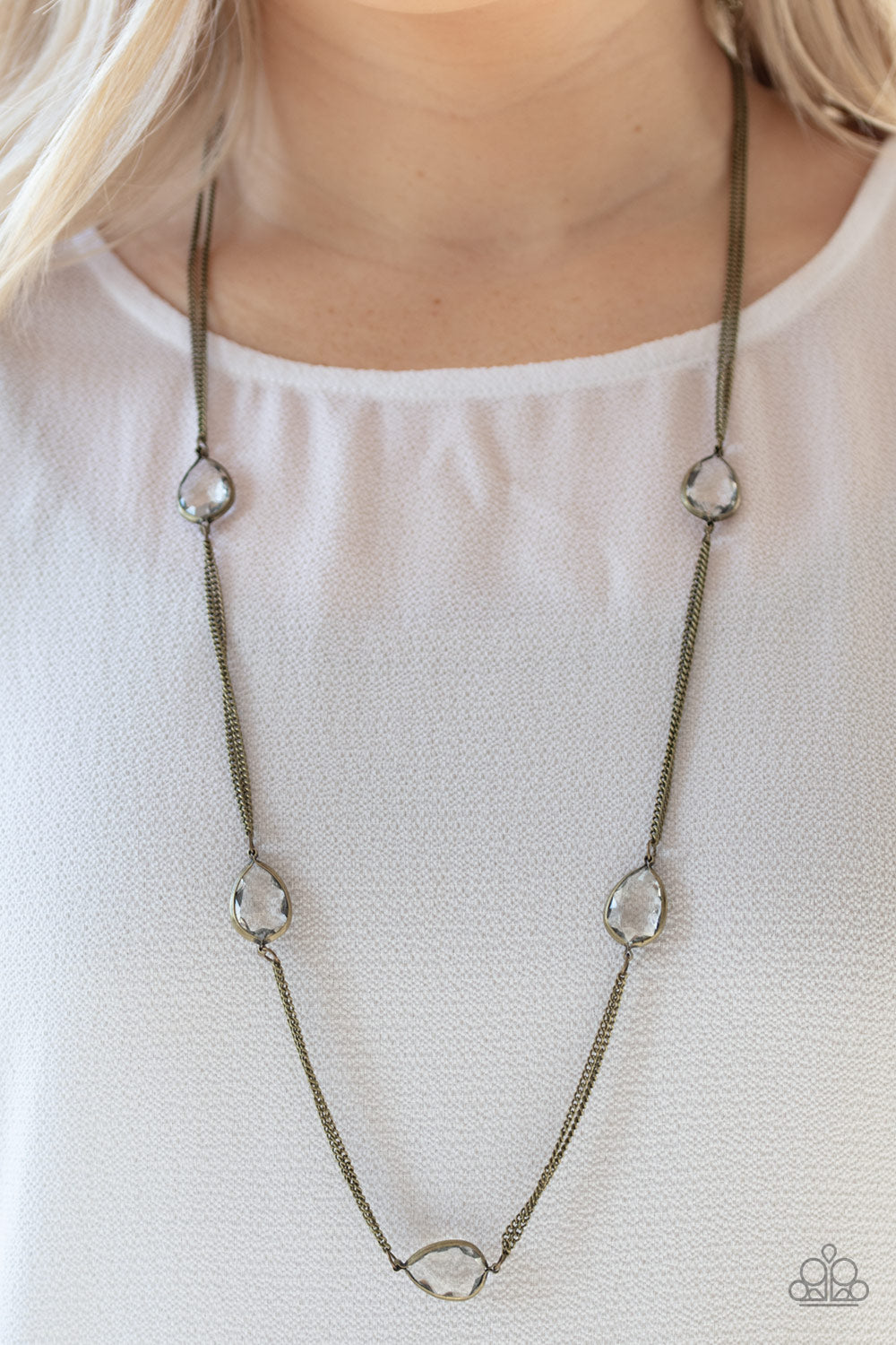 Teardrop Timelessness - Brass Necklace - Paparazzi Accessories - Glassy white teardrops attach to sections of antiqued brass chain across the chest, creating a refined display. Features an adjustable clasp closure. Sold as one individual necklace.