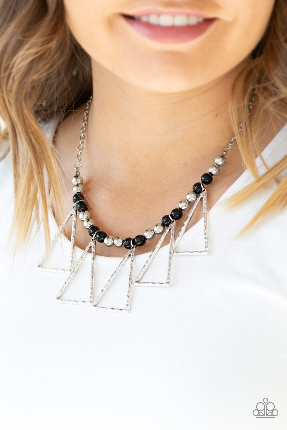 Terra Nouveau - Black and Silver Necklace - Paparazzi Accessories - A collection of shiny silver and refreshing black beads are threaded along an invisible wire below the collar. Hammered triangular frames swing from the bottom of the colorful compilation, creating an artistic fringe. Features an adjustable clasp closure.