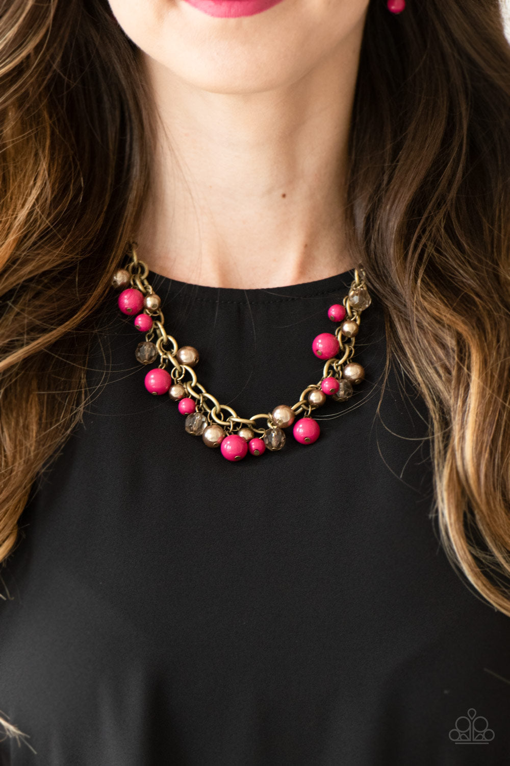 The GRIT Crowd - Pink and Brass Necklace - Paparazzi Accessories - Pearly brass, polished pink, and glittery crystal-like beads swing from a bold brass chain, creating a refined fringe below the collar. Features an adjustable clasp closure.