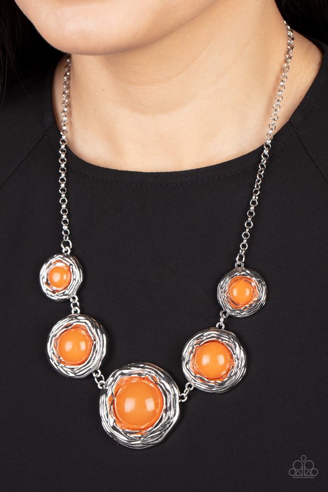 The Next Nest Thing - Orange and Silver Necklace - Paparazzi Accessories - Gradually increasing in size, a bubbly collection of oversized glassy orange beads adorn the centers of folds of silver buds below the collar for a seasonal fashion. Features an adjustable clasp closure. Sold as one individual necklace.