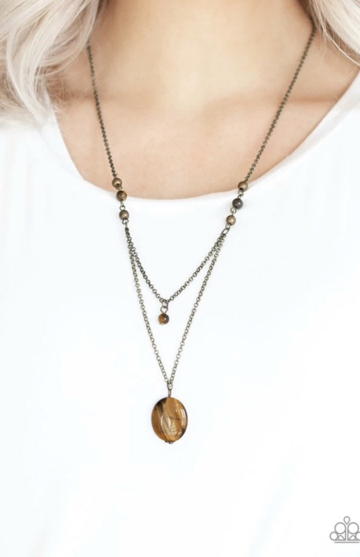 Time To Hit The ROAM - Brass - Tiger's Eye Necklace - Paparazzi Accessories - Rows of dainty brass and glassy Tiger's Eye stone beads give way to two shimmery brass chain layers. A dainty Tiger's Eye stone bead swings from the uppermost strand, while a glassy Tiger's Eye stone pendant swings from the lowermost chain for a stacked look. Features an adjustable clasp closure.