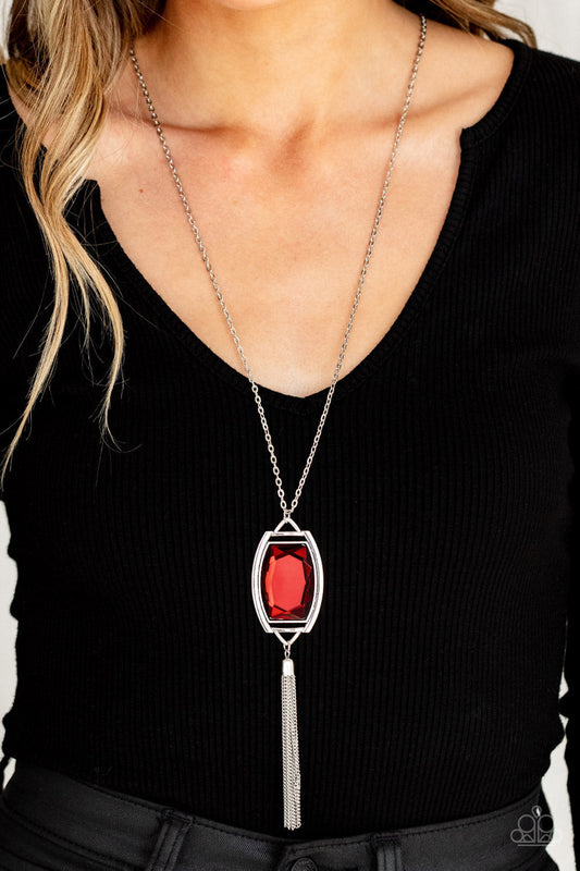 Timeless Talisman - Red Gem - Silver Fashion Necklace - Paparazzi Accessories - Encased in an antiqued silver frame, an oversized red gem swings from the bottom of an ornate silver chain. A shimmery silver chain tassel swings from the bottom of the sparkly pendant, creating a regal talisman. Features an adjustable clasp closure.