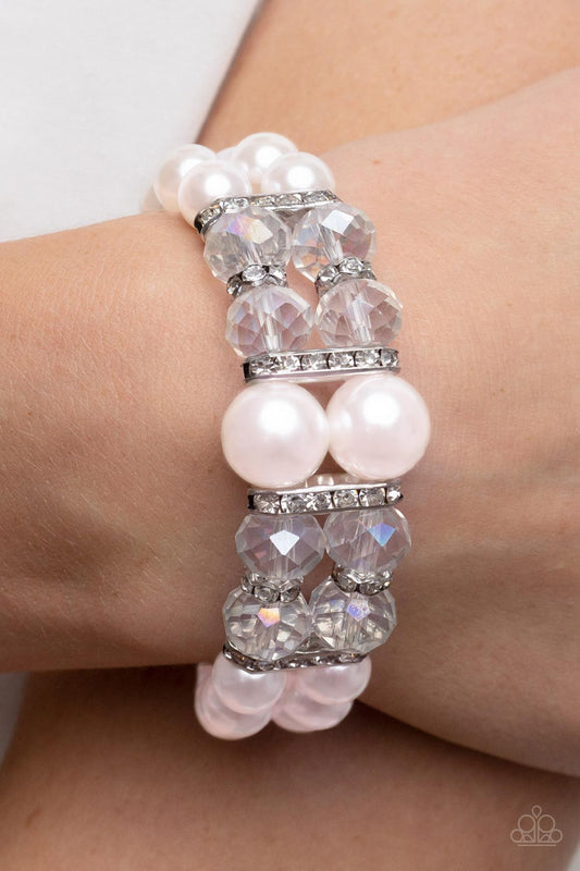 Timelessly Tea Party - Pink Pearl Bracelet - Paparazzi Accessories - Stretchy pair of bubbly pink pearl bracelets with white rhinestone encrusted silver rings, iridescent crystal-like beads, and oversized pink pearls for a timeless finish.