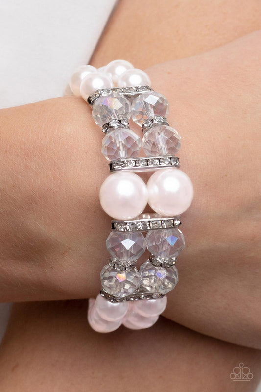 Timelessly Tea Party - Pink Pearl Bracelet - Paparazzi Accessories - Stretchy pair of bubbly pink pearl bracelets with white rhinestone encrusted silver rings, iridescent crystal-like beads, and oversized pink pearls for a timeless finish.