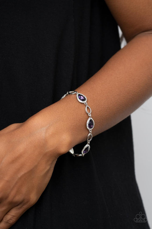 Timelessly Teary - Purple and Silver Bracelet - Paparazzi Accessories - Bordered in glassy white rhinestones, glittery purple teardrop gems link with airy silver teardrop frames around the wrist for a timeless twinkle. Features an adjustable clasp closure. Sold as one individual bracelet.