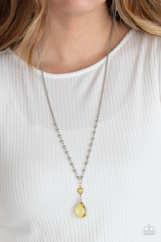 Titanic Splendor - Yellow Primrose Gem and Silver Necklace - Paparazzi Accessories - Primrose teardrop gem dangles from a lengthened silver chain. A small heart-shaped Primrose gem and shiny round beads accentuate the majestic fashion look of this necklace.