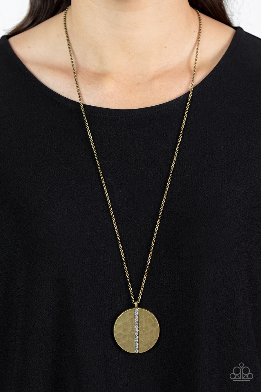 Token of My Gratitude - Brass Necklace - Paparazzi Accessories - An icy row of glittering white rhinestones is pressed into the center of a hammered brass disc, splitting the oversized pendant seemingly in two as it swings from the bottom of an extended brass chain for a dramatic effect.