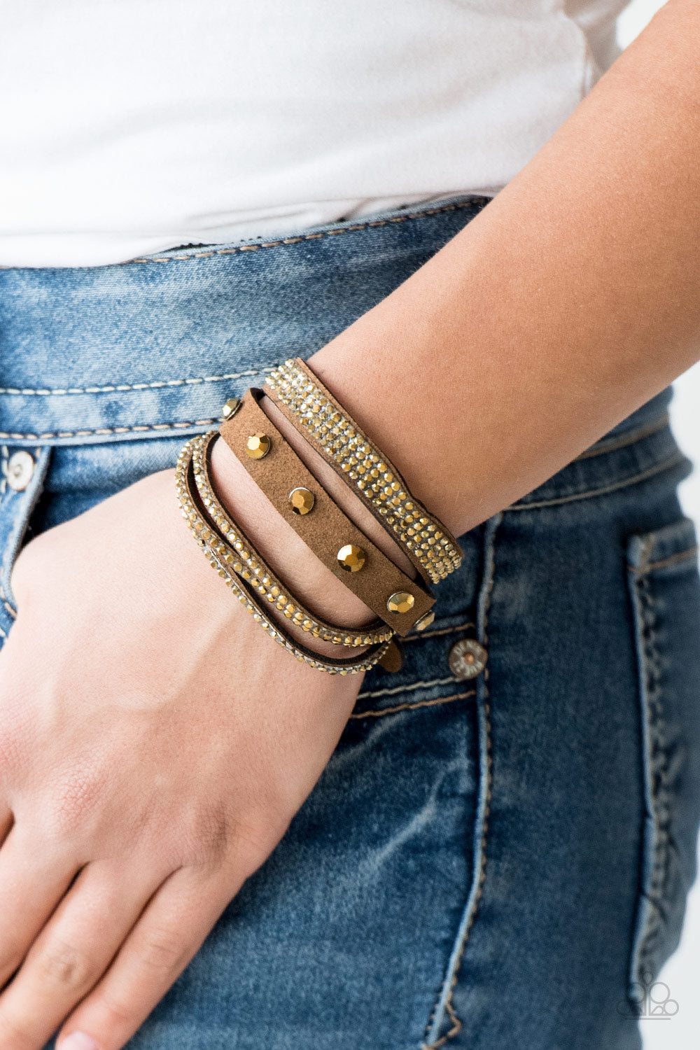 Totally Rockable - Brass and Brown Wrap Bracelet - Paparazzi Accessories - Brown suede is encrusted in sections of glittery aurum rhinestones for a sassy look. The band double wraps around the wrist for a fierce one-of-a-kind look. Features an adjustable snap closure.