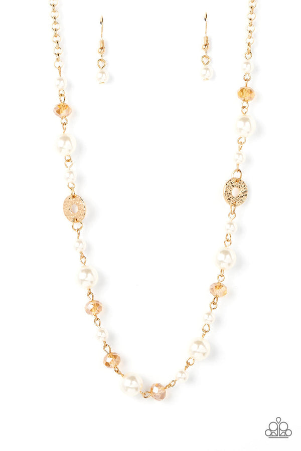 Traditional Transcendence - Gold Pearl Necklace - Paparazzi Accessories - A timeless collection of white pearls, golden crystal-like beads, and hammered gold discs delicately connects below the collar, resulting in a refined display. Features an adjustable clasp closure. Sold as one individual necklace.