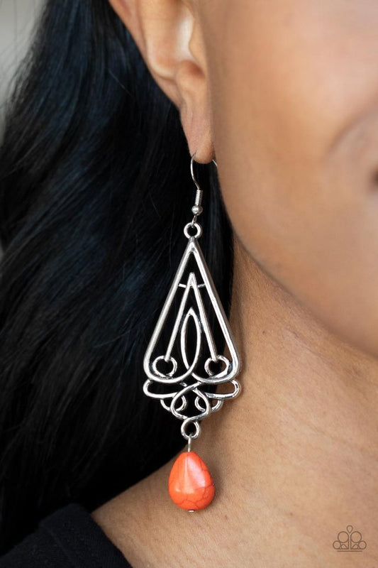 Transcendent Trendsetter - Orange and Silver Earrings - Paparazzi Accessories - A refreshing orange teardrop stone swings from the bottom of an ornate triangular frame, creating a seasonal statement.