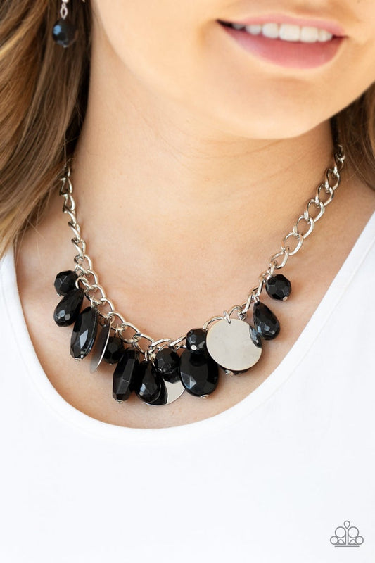 Treasure Shore - Black and Silver Necklace - Paparazzi Accessories - A collection of glassy black beads swings playfully from the bottom of a dramatic silver chain. Glistening silver discs trickle between the colorful beads, creating a refreshing fringe below the collar with shimmering reflections of light. Features an adjustable clasp closure.