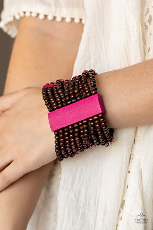 Tropical Trendsetter - Pink and Brown Wood Bracelet - Paparazzi Accessories - Stacked layers of round wooden beads are threaded along stretchy bands creating a free-spirited statement. Two pink wooden bars connect the strands while vibrant pink accent beads are lined up across the center for an island-inspired vibe.