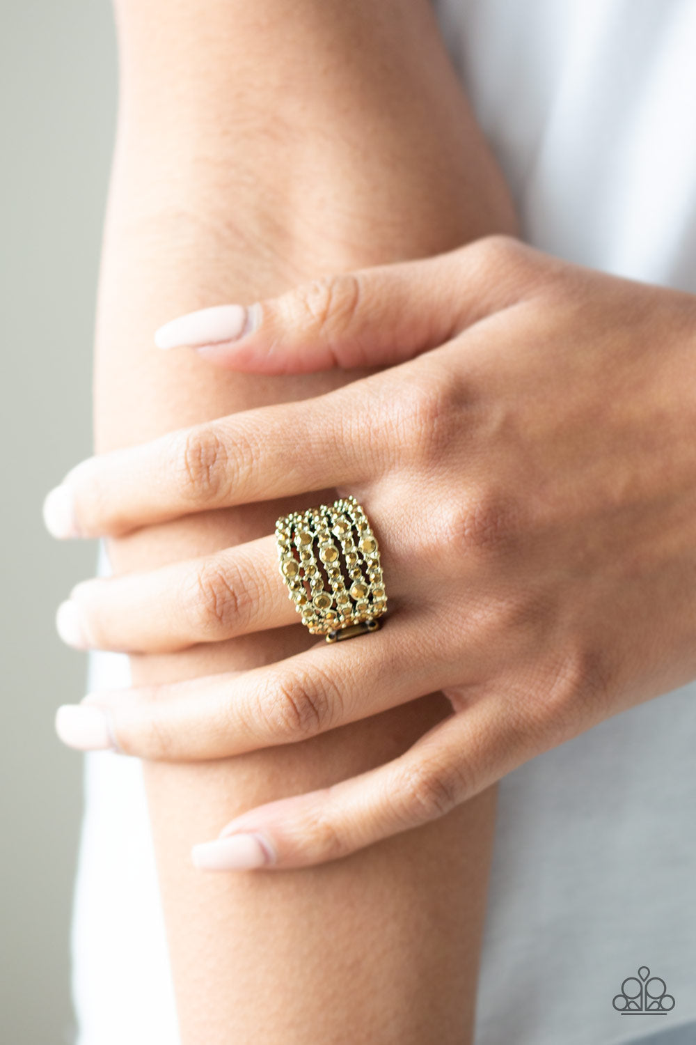 Truly Treasured - Brass Fashion Ring - Paparazzi Accessories - Row after row of glittery aurum rhinestones are encrusted along studded brass bands for a dazzling look. Features a stretchy band for a flexible fit. Sold as one individual ring.