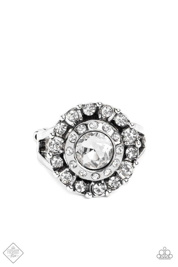 Twinkling Trance - White Gem Silver Ring - Paparazzi Accessories - A brilliant white gem is bordered by two radiating halos of sparkling rhinestones and tiny silver studs and then set atop a pair of silver bands that arc across the finger in a dazzling finish. Features a stretchy band for a flexible fit. Sold as one individual ring.