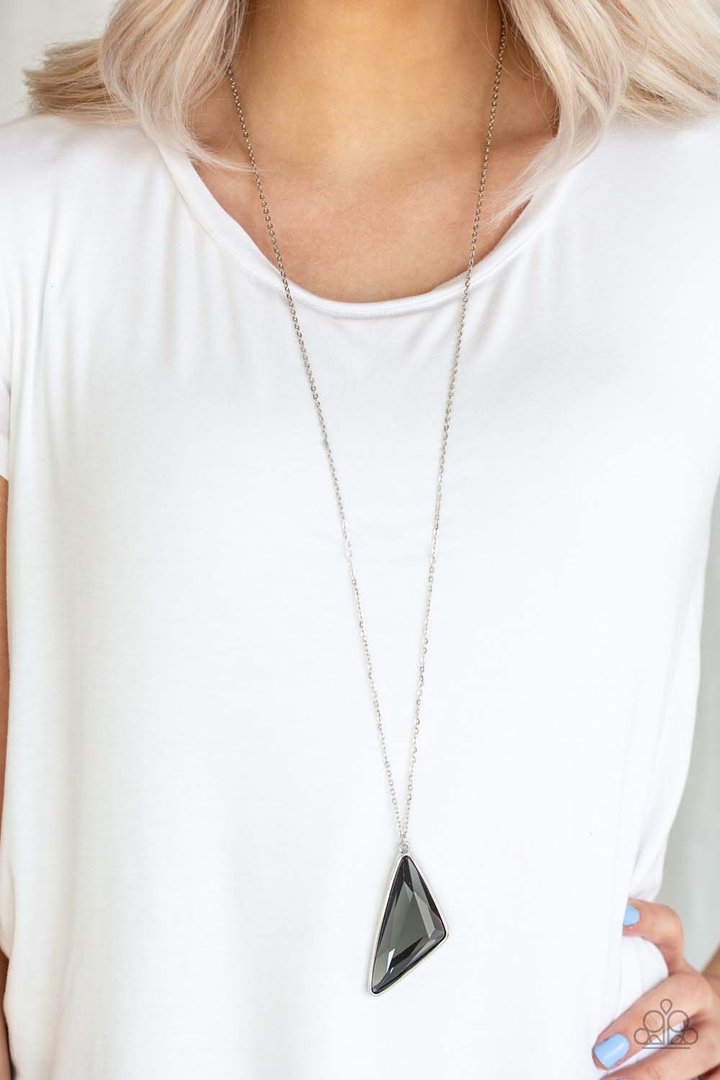 Ultra Sharp - Silver and Smoky Gem Necklace - Paparazzi Accessories - Cut into a striking triangular shape, a faceted smoky gem swings from the bottom of a lengthened silver chain for an edgy-glamorous fashion. Features an adjustable clasp closure.