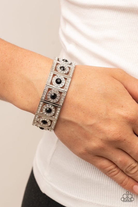 Ultra Upscale - Black and Silver Bracelet - Paparazzi Accessories - A glassy black rhinestone is pressed into a ring of glitzy white rhinestones inside a rectangular silver frame dusted in dazzling white rhinestones. The timeless frames sparkle along stretchy bands around the wrist.