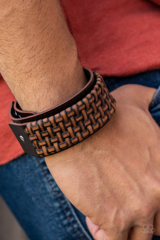 Urban Expansion Brown Leather Bracelet - Paparazzi Accessories - Bejeweled Accessories By Kristie - Distressed leather laces weave into a wicker-like pattern, creating a thick band of texture that wraps around a leather band. The textured overlay is studded in place across the front of the brown leather band, resulting in a rustic centerpiece. Features an adjustable snap closure bracelet. Trendy fashion jewelry for everyone .