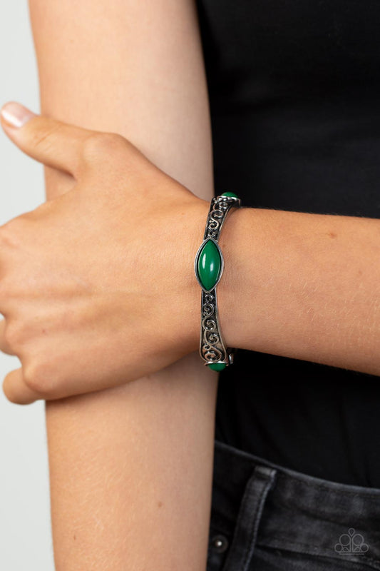 Veranda Variety - Green and Silver Bracelet - Paparazzi Accessories - Dotted with round and marquise green beads, antiqued silver frames that are embossed in a vine-like motif are threaded along stretchy bands around the wrist for a colorful pop of seasonal inspiration.