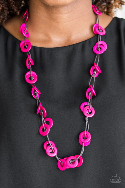 Waikiki Winds - Pink Wood Necklace - Paparazzi Accessories - Shiny brown cording knots around vivacious pink wooden discs, creating a colorful display across the chest. Features a button loop closure. Sold as one individual necklace.