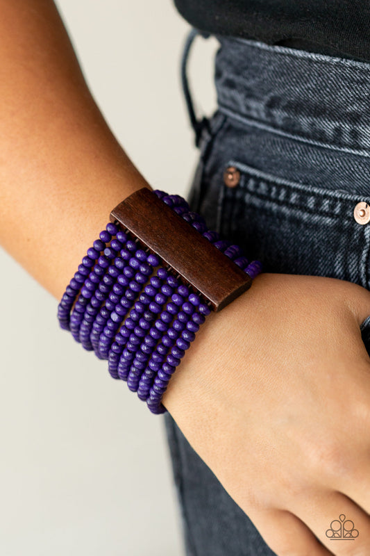 Waikiki Wonderland - Purple Wood Bracelet - Paparazzi Accessories - Held together with brown wooden rectangular frames, rows of vivacious purple wood beads are threaded along stretchy bands around the wrist for a whimsically layered look. Sold as one individual bracelet.