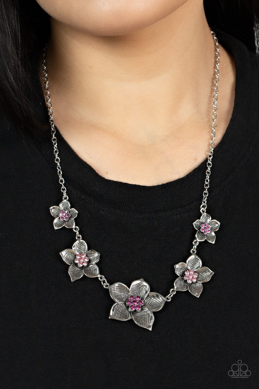 Wallflower Wonderland - Pink and Silver Necklace - Paparazzi Accessories - Charming collection of antiqued silver flowers in diminishing sizes delicately link across the collar. The detailed petals are etched in antiqued silver and fan out from lovely pink rhinestone centers resulting in a blissful enchantment stylish necklace.