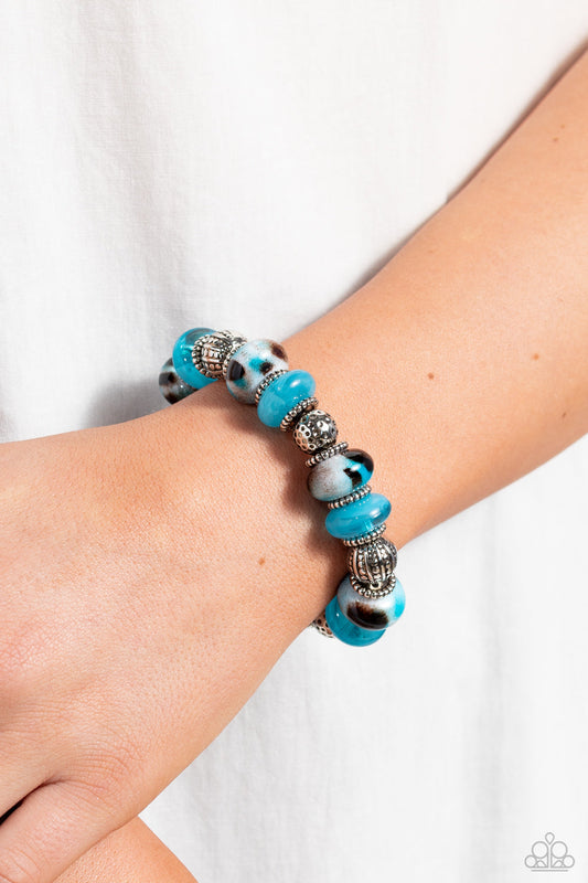 Warped Wayfarer - Blue Turquoise Bracelet - Paparazzi Accessories - An earthy collection of dotted silver beads, rounded milky turquoise beads, studded silver rings, turquoise-spotted ceramic-like beads and textured silver beads are threaded along an elastic stretchy band around the wrist for an authentic artisan flair.