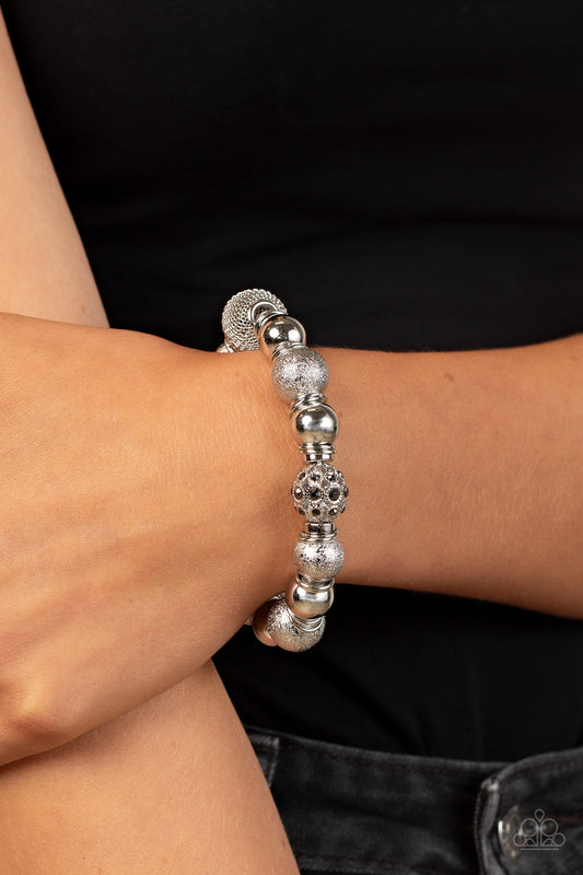 We Totally Mesh - Silver Fashion Bracelet - Paparazzi Accessories - An oversized collection of shimmery silver beads, silver rings, hematite rhinestone dotted accents, and wire mesh beads are threaded along stretchy bands around the wrist for a glitzy finish. Sold as one individual bracelet.