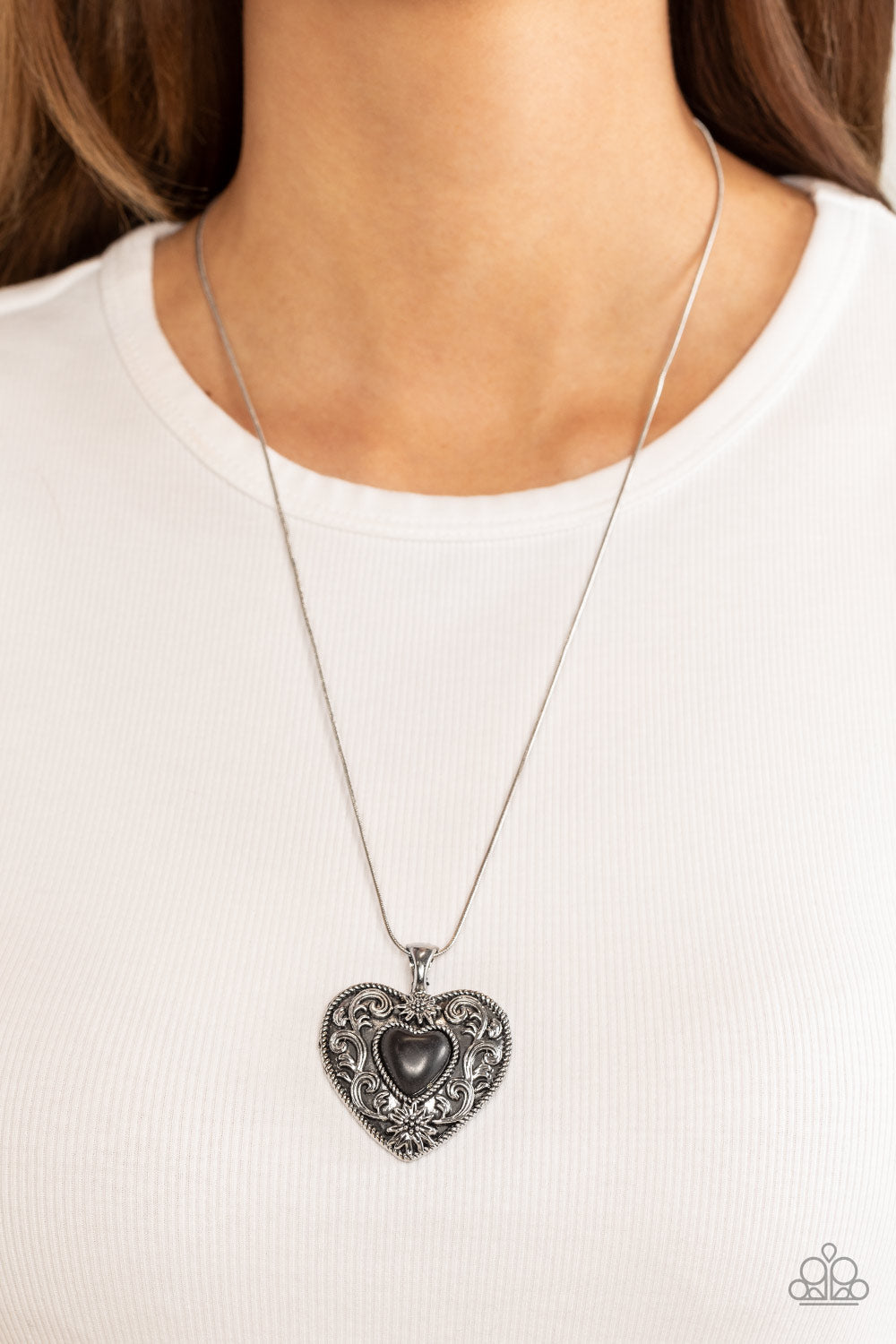 Wholeheartedly Whimsical - Black and Silver Necklace - Paparazzi Jewelry - Bejeweled Accessories By Kristie - Embossed in whimsical flowers and vines, a rustic silver heart frame is adorned with a black stone heart center for an adoring artisan finish as it glides along a rounded silver snake chain across the chest. Features an adjustable clasp closure.