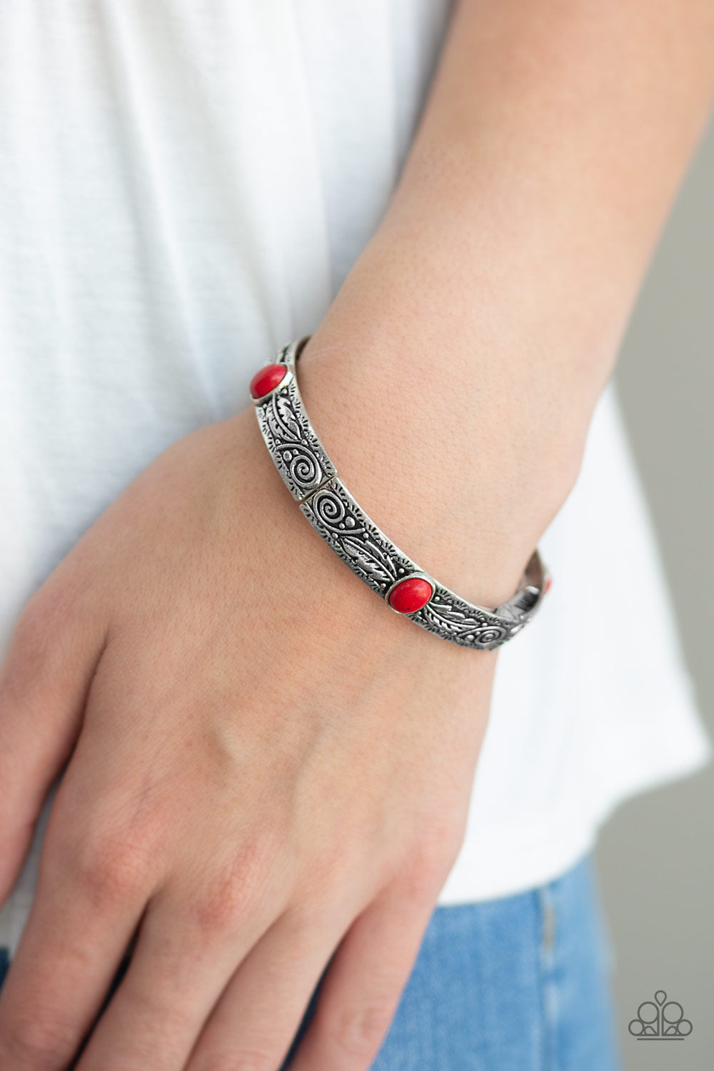 Wild West Story - Red and Silver Stretch Bracelet - Paparazzi Accessories - Embossed in swirling silver and feather like detail, antiqued silver frames are threaded along stretchy bands around the wrist. Fiery red stones adorn the centers of the Southwestern frames for a seasonal finish. Sold as one individual bracelet.