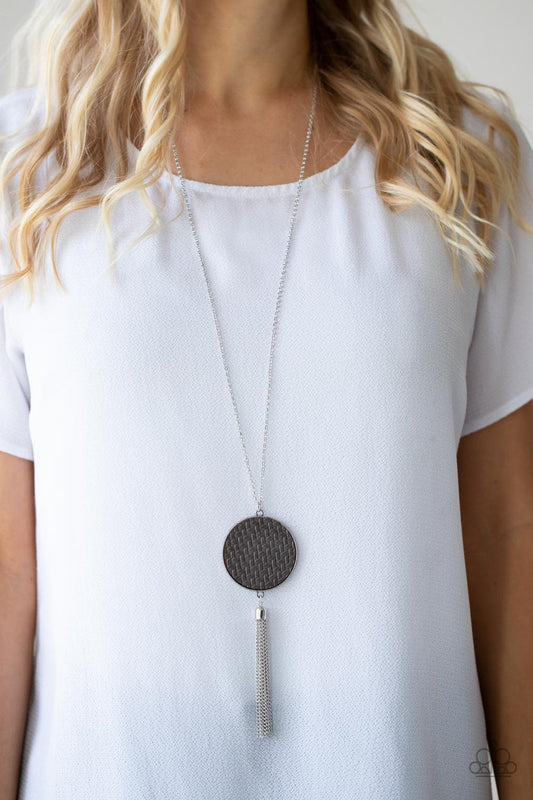 Wondrously Woven - Silver Necklace - Paparazzi Accessories - Ultimate Gray leather is pressed into a studded circular frame at the bottom of a lengthened silver chain. Capped in a frame, a silver chain tassel streams out from the colorful pendant.