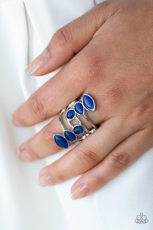 Wraparound Radiance - Blue and Silver Fashion Ring - Paparazzi Accessories - Featuring round, teardrop, and marquise shapes, two frames of glowing blue cat's eye stones stack across a layered silver band for an all around radiance. Features a stretchy band for a flexible fit. Sold as one individual ring. 