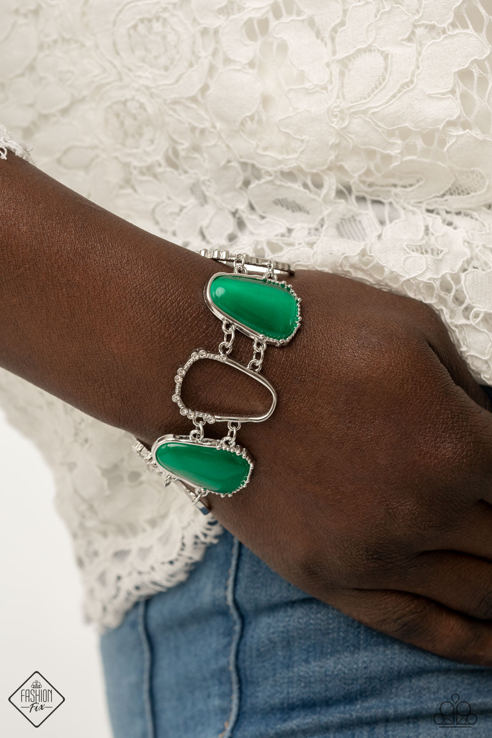 Yacht Club Couture - Green and Silver Bracelet - Paparazzi Accessories - Encased in studded silver frames, a tranquil collection of asymmetrical mint cat’s eye stone teardrops and airy silver frames delicately link around the wrist for an ethereally sparkly display. A sprinkling of rhinestones accent the open frames, adding a touch of elegance to the piece. Features an adjustable clasp closure.